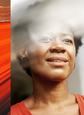 woman entrepreneur proudly looking out of a window